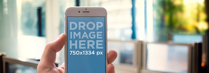 Wide Mockup of an iPhone 6 with an Office Background