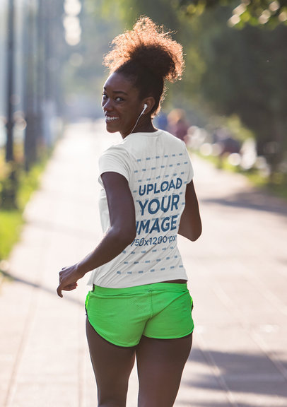 Back-View Tee Mockup Featuring a Female Jogger Wearing Headphones