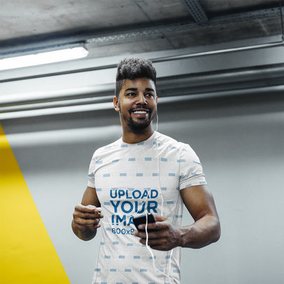 Heather T-Shirt Mockup Featuring an Athletic Man with Headphones