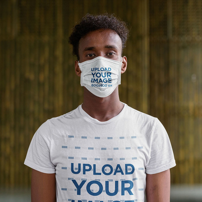 Mockup of a Serious Young Man Wearing a Tee and a Face Mask