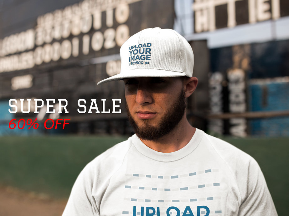 Bearded Man Wearing a Baseball Hat Mockup Near a Board