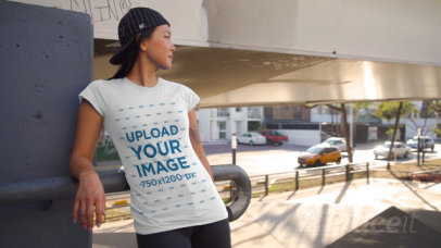 T-Shirt Video of a Woman with an Arm Tattoo Posing by Passing Cars