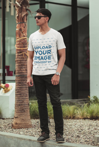 V-Neck T-Shirt Mockup of a Man Standing in the Street