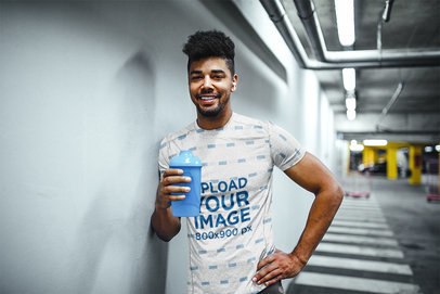 Sublimated T-Shirt Mockup of a Man Taking a Break from Working Out 