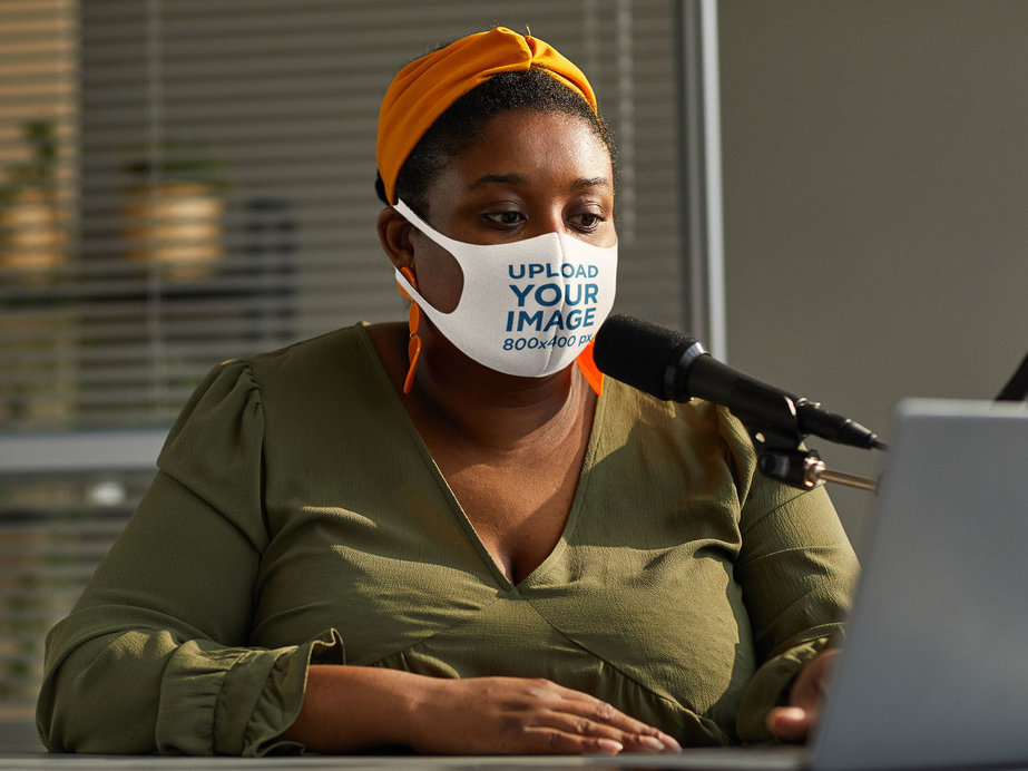 Mockup of a Woman Wearing a Face Mask While Doing a Radio Show