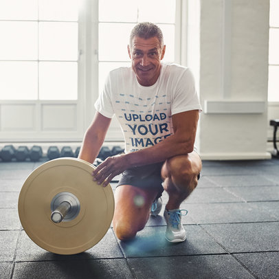 Round-Neck T-Shirt Mockup Featuring a Fitness Man With Weights at the Gym