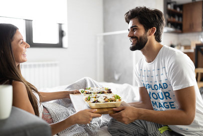 T-Shirt Mockup of a Man Bringing Food to His Girlfriend in Bed