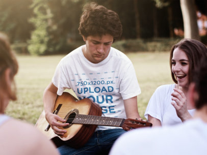 Round-Neck T-Shirt Mockup of a Serious Man Playing the Guitar With Friends