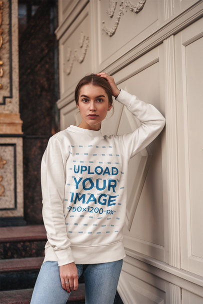 Round-Neck Sweatshirt Mockup of a Woman Leaning Against a Wall