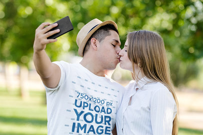 T-Shirt Mockup of a Man Taking a Selfie Kissing His Girlfriend