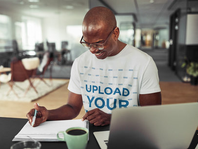 Round-Neck T-Shirt Mockup of a Man with Glasses Working at an Office