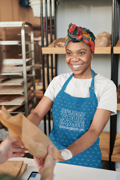 Apron Mockup Featuring a Smiling Woman Selling Bread