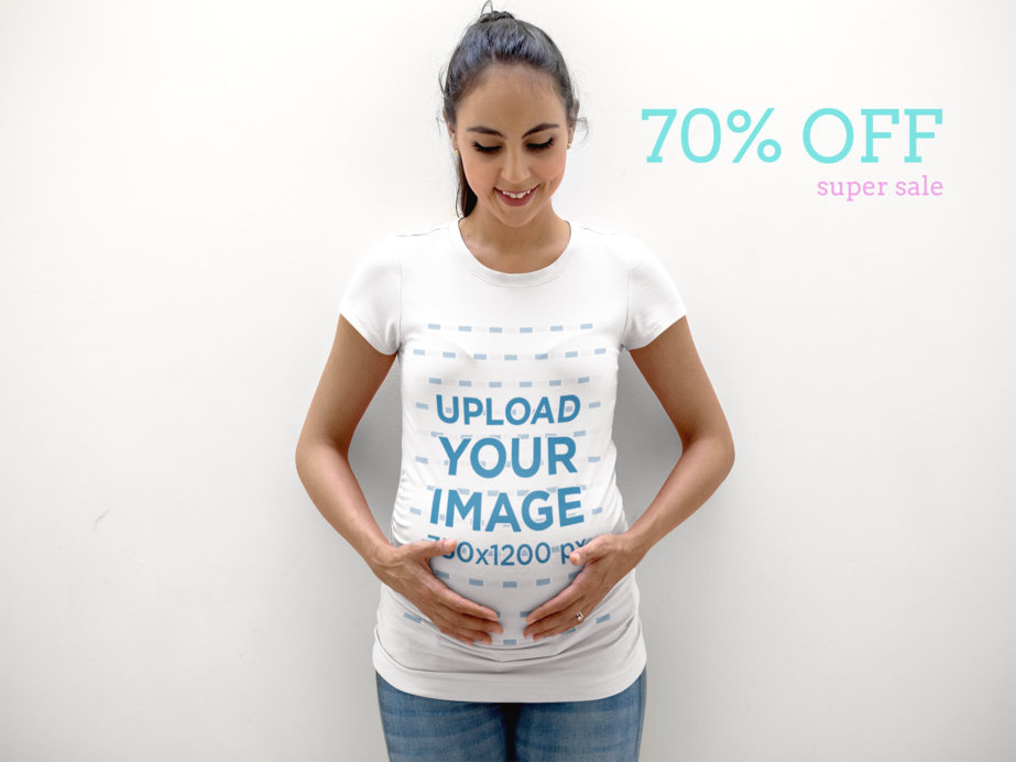 Pregnant Mom Wearing a T-Shirt Template Lying Against a White Wall