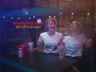 Two Women Laughing While Wearing Different T-Shirts Mockup at a Restaurant