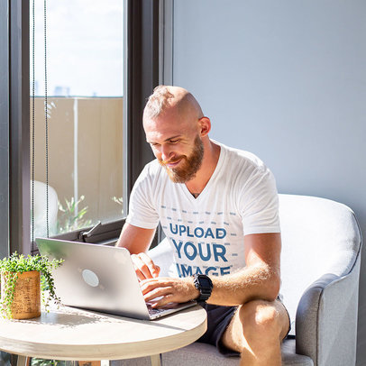 V-Neck T-Shirt Mockup of a Man Working by a Window m6318-r-el2