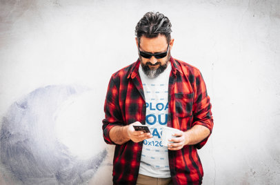 T-Shirt Mockup of a Man With a Flannel Checking His Phone