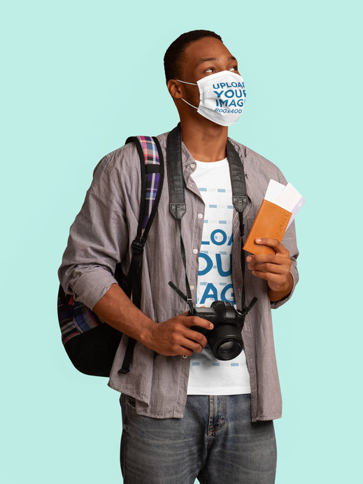 T-Shirt and Face Mask Mockup of a Man Holding a Passport and a Camera