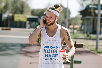 Tank Top Mockup Featuring a Tattooed Man on the Phone