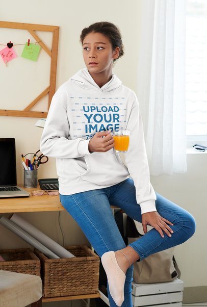 Pullover Hoodie Mockup of a Woman Holding a Glass of Orange Juice at Home M11580-r-el2