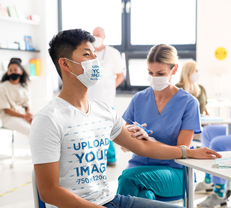 Mockup of a Man Wearing a Tee and a Face Mask While Receiving His Vaccine