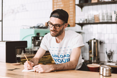 T-Shirt Mockup of a Man Working at a Coffee Shop