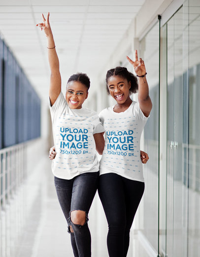 Round-Neck Tee Mockup of Two Smiling Women Hugging and Making Peace Hand Signs