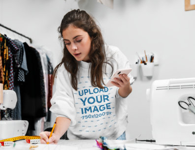 Sweatshirt Mockup Featuring a Woman Working at a Fashion Design Studio m8172-r-el2