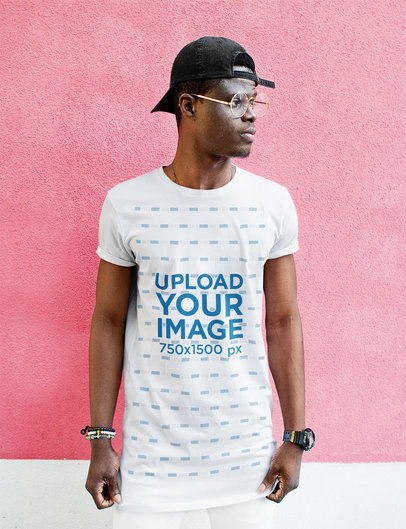T-Shirt Mockup of a Man Standing in Front of a Bright-Colored Wall M11013-r-el2
