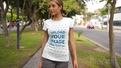 T-Shirt Video of a Confident Woman Walking by a Street with Trees