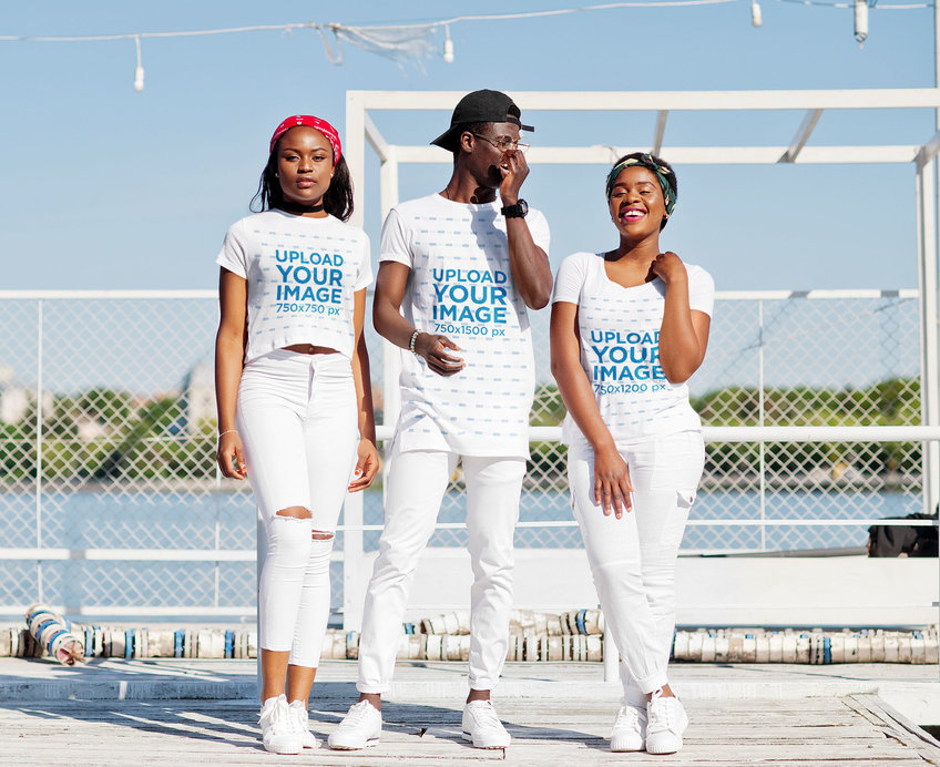 T-Shirt Mockup Featuring a Group of Friends Wearing White Pants