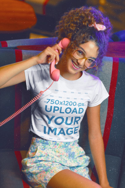 T-Shirt Mockup of a Woman with an 80's Outfit Using a Retro Telephone