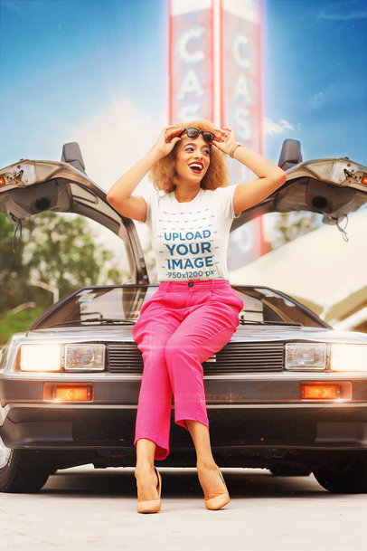 T-Shirt Mockup of a Woman in an 80s Outfit Posing By a Retro Car 