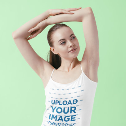 Tank Top Mockup of a Woman Lifting Her Arms at a Studio