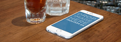 White iPhone 6 On Wooden Counter Bar Wide