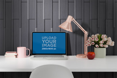 Mockup of a MacBook Placed on a White Desk Featuring a Pink Lamp