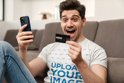 T-Shirt Mockup of an Excited Man Paying With His Phone