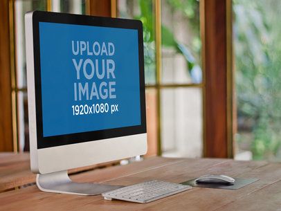 Mockup of an iMac on a Wooden Desk
