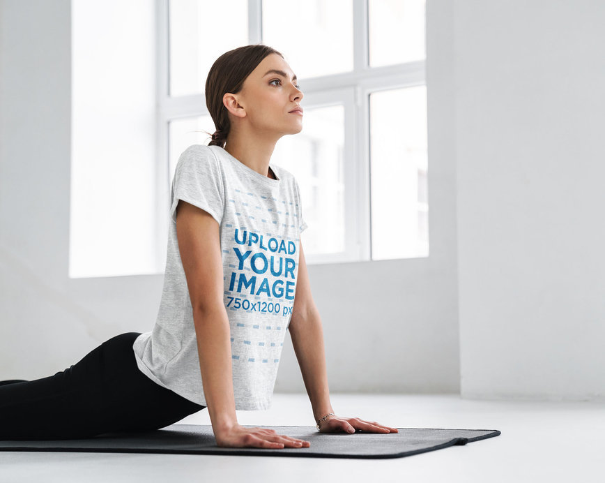 Heathered T-Shirt Mockup Featuring a Long-Haired Woman Doing Yoga