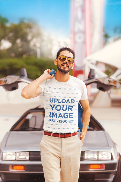 T-Shirt Mockup Featuring a Bearded Man Posing by an 80s Car 