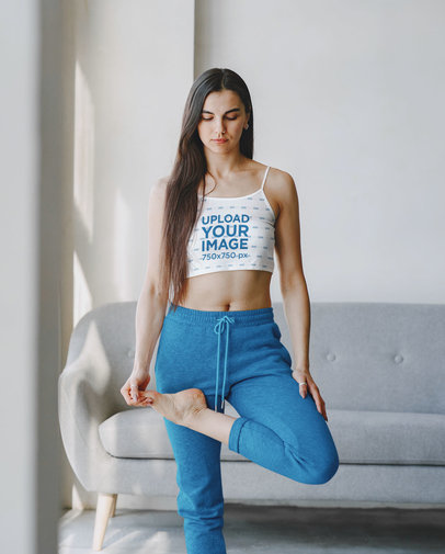 Crop Top Mockup of a Woman Stretching by a Couch at Home
