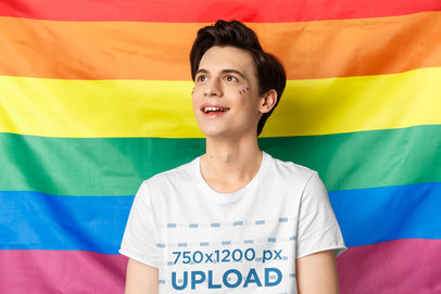 T-Shirt Mockup of a Young Man in Front of an LGBTQ Flag