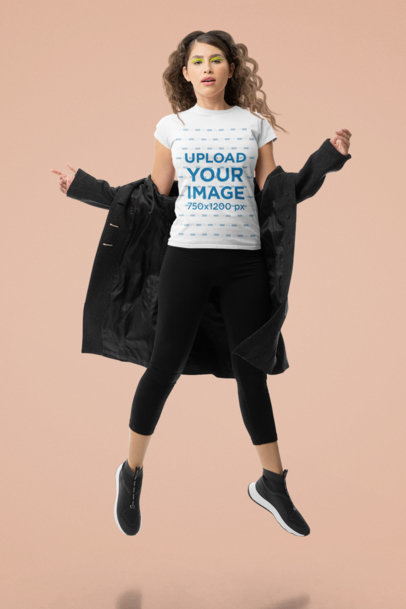T-Shirt Mockup of a Wavy-Haired Woman Jumping in a Studio M10744