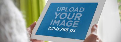 Wide Mockup of an iPad held by a Woman