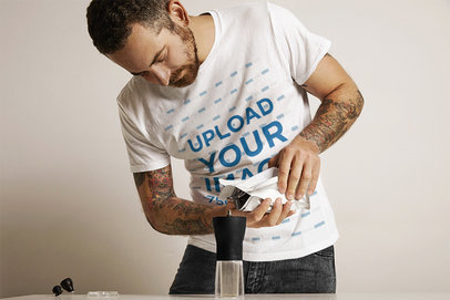 T-Shirt Mockup of a Tattooed Man Using a Coffee Grinder m6338 r-el2