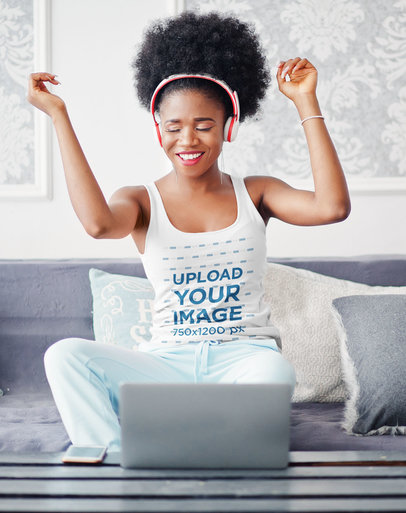 Tank Top Mockup of a Woman with Headphones Listening to Music in Her Living Room