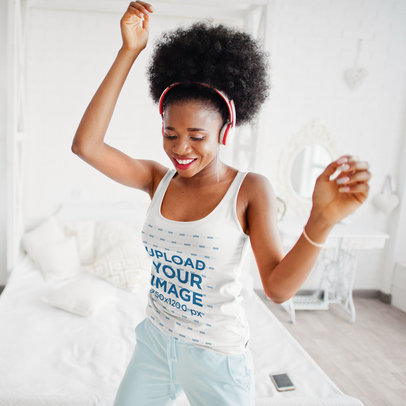 Tank Top Mockup of a Happy Woman with Headphones Dancing in Her Bedroom 
