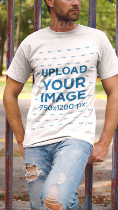 T-Shirt Video of a Man Posing by an Urban Fence