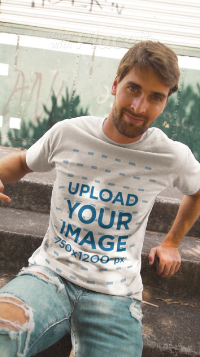 T-Shirt Video of a Man Sitting on a Stair Step Pointing at His Garments
