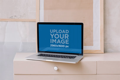 Mockup of a MacBook on a Peach-Colored Desk m11444-r-el2