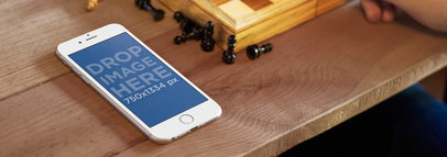 Wide Mockup of an iPhone 6 at a Chess Game